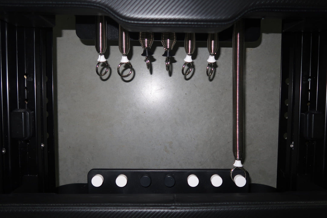 Close-up of reformer springs used for resistance training in FlowCorps Pilates classes