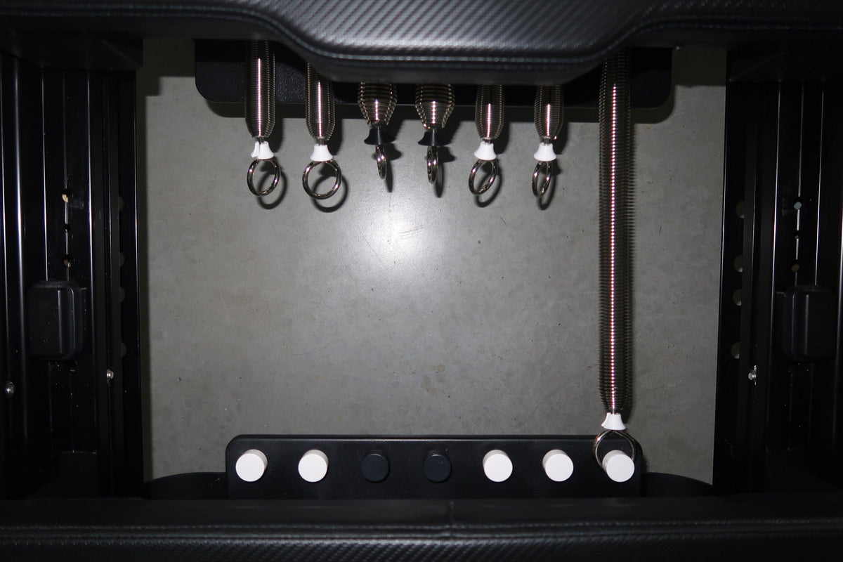 Close-up of reformer springs used for resistance training in FlowCorps Pilates classes