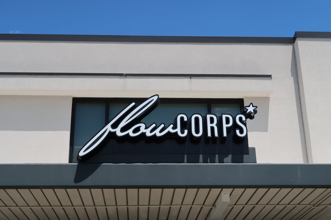 Exterior sign for FlowCorps Pilates Studio at 93 South Elliot Road, Chapel Hill NC