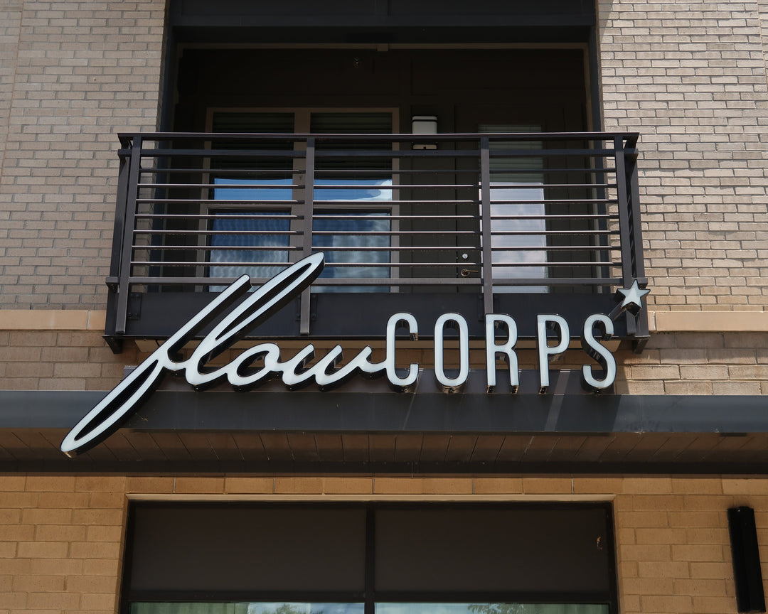Exterior sign for FlowCorps Pilates Studio at 3710 Exchange Glenwood Place, Sojourn Raleigh NC