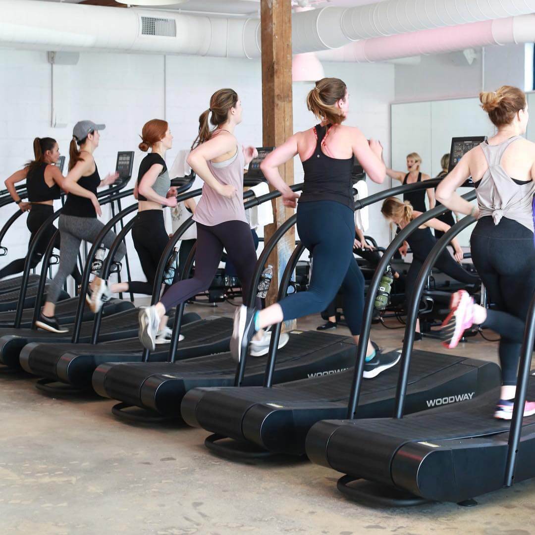 Group cardio, treadmill intervals combined with Pilates, and strength training class at FlowCorps. 