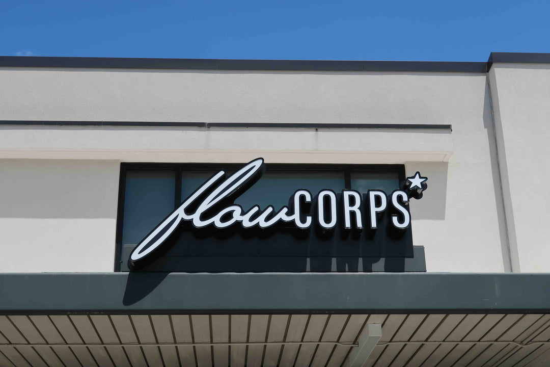Exterior sign for FlowCorps Pilates Studio at 93 South Elliot Road, Chapel Hill NC