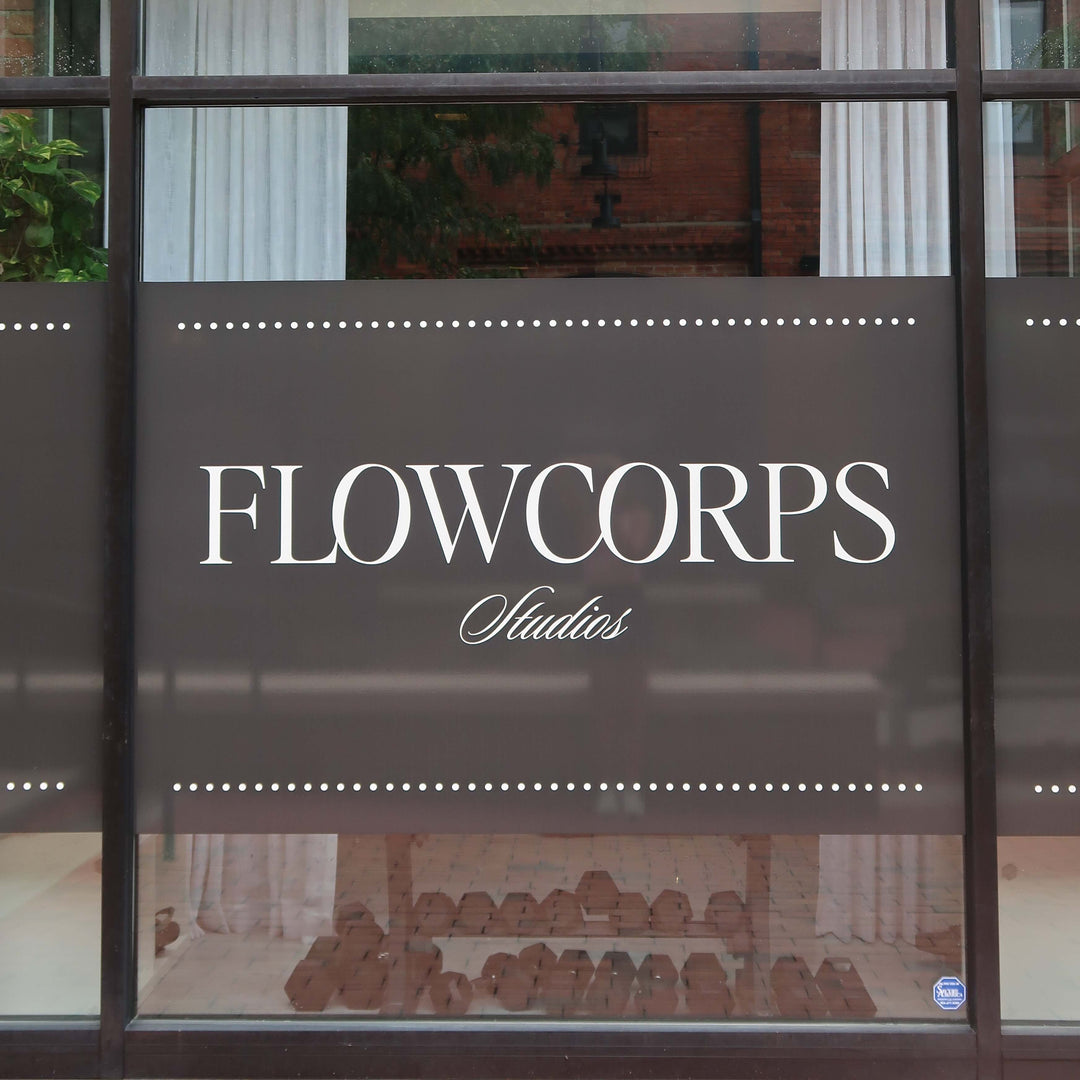 Exterior sign for FlowCorps Pilates Studio at 905 W Main St #19, Durham, NC 27701. Located in Brightleaf Square