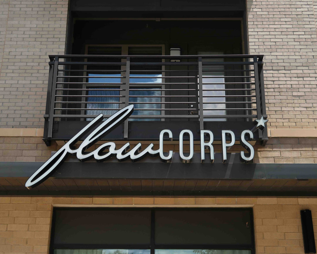 Exterior sign for FlowCorps Pilates Studio at 3710 Exchange Glenwood Place, Sojourn Raleigh NC